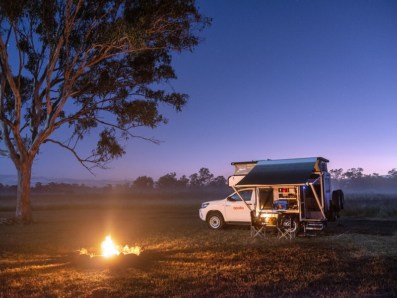 4wd camper at campsite with campfire at night